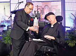 Archbishop Charles C. Thompson presents the archdiocese’s Legacy Award to Msgr. Paul Koetter during the Legacy Gala at the JW Marriott hotel in Indianapolis on Feb. 25. Msgr. Koetter received the Legacy Award in honor of his ministry to serve God and people across central and southern Indiana in his 45 years of priesthood. (Photo by Rob Banayote)