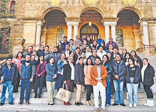 Felix Navarrete, archdiocesan director of Hispanic Ministry, front, poses outside the main entrance of Saint Meinrad Seminary and School of Theology in St. Meinrad with archdiocesan parishioners who are taking part in a new Hispanic ministry formation program. (Submitted photo) 