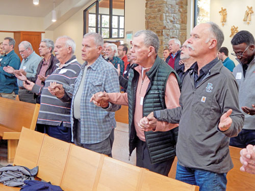 Men pray the Our Father during a liturgy celebrated on Nov. 16 at St. Agnes Church in Nashville. (Photos by Mike Krokos)