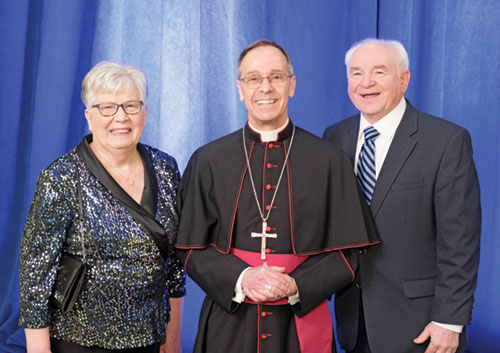 Archbishop Charles C. Thompson poses for a photo with Laura Jo and Glenn Tebbe, recipients of the archdiocese’s 2025 Legacy Award during the Legacy Gala in Indianapolis on Feb. 7. (Photo courtesy of Denis Kelly)
