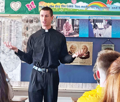 Transitional Deacon Isaac Siefker speaks on Jan. 9 to eighth-grade students at Holy Name of Jesus School in Beech Grove. He is serving at Holy Name of Jesus Parish in Beech Grove for six months prior to his priestly ordination scheduled for June 7. (Submitted photo) 
