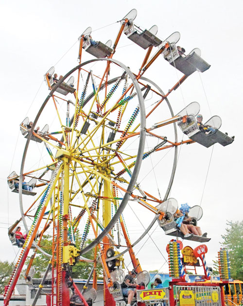 People ride a ferris wheel on May 15, 2021, at the St. Joseph Parish Festival in Shelbyville. (Photo by Sean Gallagher)