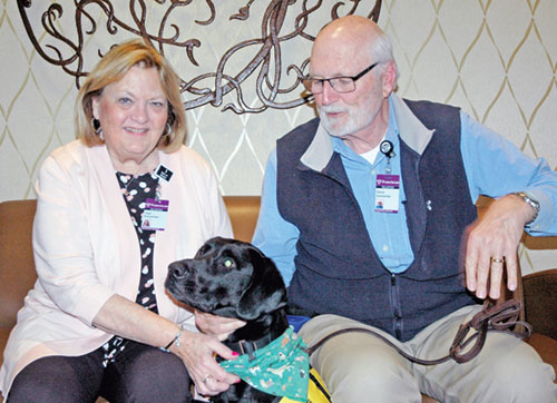Joan and Steve Gutzwiller and their therapy dog Murphy bring touches of joy and hope during their visits with cancer patients at Franciscan Health Indianapolis. (Photo by John Shaughnessy)