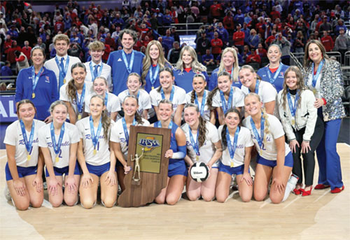 The players, coaches and managers of the volleyball team of Roncalli High School in Indianapolis celebrate winning the Class 3A Indiana state championship on Nov. 8 in Gainbridge Fieldhouse in Indianapolis. (Submitted photo)
