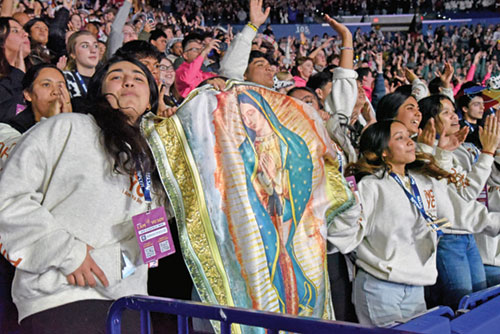 National Catholic Youth Conference participants hold up a banner of Our Lady of Guadalupe while celebrating after the end of the event’s closing Mass on Nov. 22 in Lucas Oil Stadium in Indianapolis. (Photo by Sean Gallagher)