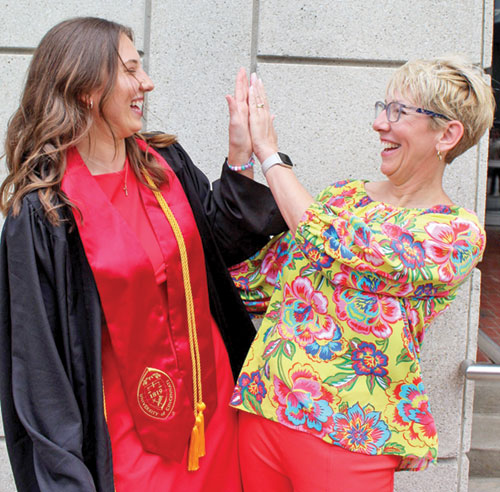 As daughter and mother respectively, Katie Huff and Kim Huff have lived the joy this school year of being co-teachers in the fourth grade at Holy Family School in New Albany. Their shared sense of fun shows in this photo from Katie&rsquo;s graduation from the University of Cincinnati in 2025. (Submitted photo)