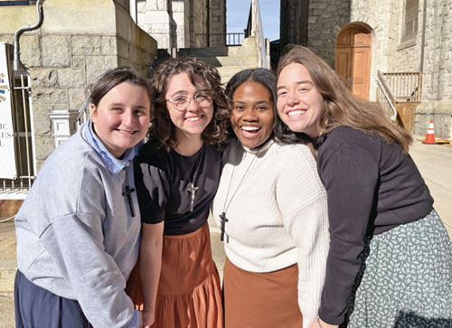 Cheyenne Johnson, second from the right, enjoys a photo moment with Guiomar Hernandez Castro, left, Annamaria Bleyer and Elly Bjork. The four friends spent the past year in a missionary program with the Franciscan Sisters of the Renewal in Atlantic City, N.J. Johnson, a member of Our Lady of the Most Holy Rosary Parish in Indianapolis, will be the team leader for the eight other young adults who have also been chosen as perpetual pilgrims for the third National Eucharistic Pilgrimage that begins on May 24 in St. Augustine, Fla. (Submitted photo)