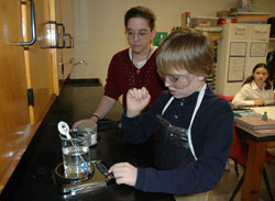 St. Rose of Lima sixth-grader William Roush of Franklin works with science teacher Amber Hayes on a chemistry experiment with new laboratory equipment. Carolyn Kurek said the dedication of the science laboratory was “a very emotional realization that what Joe [Kurek] stood for in his life was something that was going to live on.”