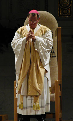 Archbishop Buechlein prays at his 10th anniversary Mass at SS. Peter and Paul Cathedral on Aug. 29, 2002. (File photo by Brandon A. Evans)