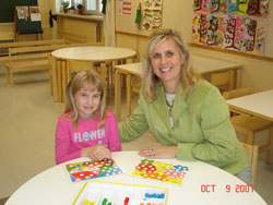 Despite the language barrier, Immaculate Heart of Mary School principal Annette Jones of Indianapolis and Annikka, a 6-year-old student at Central School of Viiala in Akaa, Finland, play a color game.	(Submitted photo)	