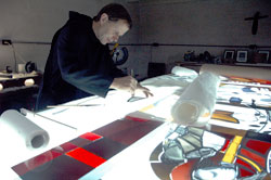 Benedictine Brother Martin Erspamer works on a stained-glass window at an art studio near Saint Meinrad Archabbey last October. He joined the monastery after spending 30 years in the Marianist order and many years working as a religious artist. (Photo by Sean Gallagher) 