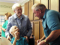 Providence Sister Susan Dinnin shares a moment of joy with Thelma and Tom Weinzapfel at A Caring Place Adult Day Services, a program of Catholic Charities Indianapolis. Sister Susan has been the site manager at A Caring Place since it opened in 1990. Thelma comes to the program three days a week, which offers Tom an opportunity to take time for himself. The Weinzapfels are members of St. Christopher Parish in Indianapolis. (Photo by John Shaughnessy) 