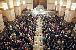 Priests process into SS. Peter and Paul Cathedral in Indianapolis on April 7 for the archdiocese’s chrism Mass. Catholics from across the archdiocese filled the cathedral for the annual liturgy during which oils are blessed and priests renew the promises made at their ordination. (Photo by Sean Gallagher) 