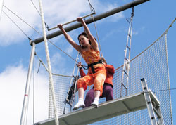 High above the ground, 13-year-old Irene Velicer begins to swing on the trapeze—part of an unusual and breathtaking physical education class at St. Charles Borromeo School in Bloomington. (Photo by John Shaughnessy)