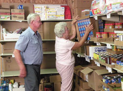 Leroy and Marlene Oser, members of St. Martin of Tours Parish in Siberia, work on Aug. 19 at Martin’s Cloak, a food and clothing bank located at their parish that is a program of Catholic Charities Tell City. (Submitted photo)