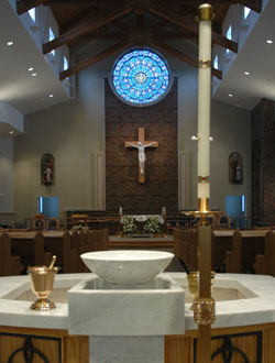 Nine priests assisted Archbishop Daniel M. Buechlein with the Mass of Dedication and Consecration of the New Altar on Feb. 28 at the new St. Anne Church in New Castle. The parish children raised the money to pay for the oak cross which holds the large corpus and hangs above the altar. (Photo by Mary Ann Wyand)