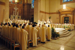 Scores of priests who minister in the Archdiocese of Indianapolis join Archbishop Daniel M. Buechlein in praying the eucharistic prayer during the annual chrism Mass on April 7, 2009, at SS. Peter and Paul Cathedral in Indianapolis. Father Patrick Beidelman, the archdiocesan director of liturgy, is leading a series of workshops to help priests in central and southern Indiana prepare to use the new English translation of the Roman Missal—the texts for the Mass—which will take effect during the weekend of Nov. 26-27, 2011. (File photo by Sean Gallagher)