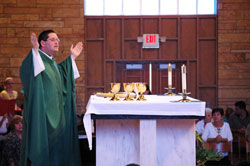 Father Eric Augenstein, pastor of Our Lady of Perpetual Help Parish in New Albany, prays the eucharistic prayer during a Sept. 17 Mass at his parish’s church. Our Lady of Perpetual Help and other parishes across central and southern Indiana have taken many approaches to preparing archdiocesan Catholics for the new Mass translation to be implemented on the weekend of Nov. 26-27. (Submitted photo)