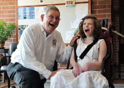 Deacon Thomas Ward poses for pictures with Leia Stone, a St. Simon the Apostle parishioner and SPRED participant, after the archdiocesan Special Religious Development Mass on June 10 at St. Lawrence Church in Indianapolis. Deacon Daniel Collier also assisted with the liturgy. (Photo by Mary Ann Garber)