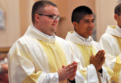Transitional Deacons Douglas Marcotte, left, and Martin Rodriguez smile during the June 23 Mass at SS. Peter and Paul Cathedral in Indianapolis during which both were ordained alongside 16 permanent deacons. They expect to be ordained to the priesthood in June 2013. (Photo by Mary Ann Garber)