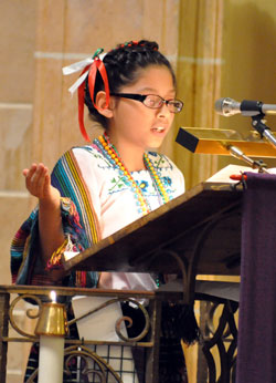 Jennifer Garza, a member of St. Anthony Parish in Indianapolis, leads the singing of the responsorial psalm during a Dec. 12 feast day Mass in honor of Our Lady of Guadalupe at her parish’s church. (Photos by Sean Gallagher)