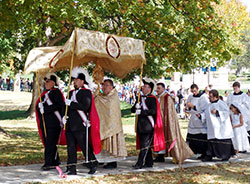 Father Robert Robeson, rector of the Bishop Simon Bruté College Seminary in Indianapolis, carries the monstrance during the “Eucharistic Rosary Rally for the Protection of Our Religious Liberties” procession on Sept. 30, 2012, at Marian University in Indianapolis. (Criterion file photo)