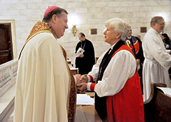 Archbishop Joseph W. Tobin exchanges a sign of peace with Bishop Catherine Waynick, bishop of the Episcopal Diocese of Indianapolis, during a Jan. 19 ecumenical prayer service at the Blessed Sacrament Chapel of SS. Peter and Paul Cathedral in Indianapolis. Co-sponsored by the Archdiocese of Indianapolis and the Church Federation of Greater Indianapolis, the prayer service kicked off the observance of the Week of Prayer for Christian Unity in the city, which runs through Jan. 25. (Photo by Sean Gallagher)