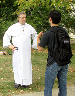 Dominican Father Simon-Felix Michalski, associate pastor of St. Paul Catholic Center, talks with an Indiana University student on the Bloomington campus in this Aug. 26, 2013, photo. Father Simon is meeting weekly with the student leaders of the small group program the parish’s campus ministry launched this semester. (Photo courtesy Jon Blau of the Herald-Times)