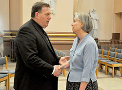 Archbishop Joseph W. Tobin speaks with Jan Erlenbaugh Gaddis after a May 21 press conference in SS. Peter and Paul Cathedral in Indianapolis in which Archbishop Tobin announced decisions regarding the Connected in the Spirit planning process for the four metropolitan Indianapolis deaneries. Erlenbaugh Gaddis is a longtime member of Holy Cross Parish in Indianapolis, one of three parishes that Archbishop Tobin said would be closed as of Nov. 30. (Photo by Sean Gallagher)