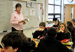 Jenny Lents, a language arts teacher at St. Louis School in Batesville, prays with her students before each class. She notes, “I remind my students that if they put God first in everything they do, things go better.” (Submitted photo)