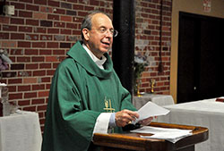 Baltimore Archbishop William E. Lori gives a homily during a July 18 Mass at a Knights of Columbus hall in New Albany during a celebration with some of his classmates of the 50th anniversary of their graduation from the eighth grade at Our Lady of Perpetual Help School, also in New Albany. Prior to the Mass, Archbishop Lori, who is chairman of the U.S. bishops’ Ad Hoc Committee for Religious Liberty, spoke with The Criterion about recent changes in the religious liberty landscape in America. (Photo by Sean Gallagher)