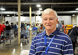 In the midst of another busy day at the Indianapolis food pantry of the Society of St. Vincent de Paul, John Ryan leads the all-volunteer group’s efforts to help people escape the cycle of poverty. (Photo by John Shaughnessy)