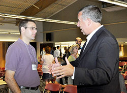 Brad Macke, left, religion teacher and campus minister at Oldenburg Academy in Oldenburg, asks a question of Curtis Martin, founder and chief executive officer of Fellowship of Catholic University Students (FOCUS), after a session at the St. John Bosco conference in Steubenville, Ohio. (Photo by Natalie Hoefer) 
