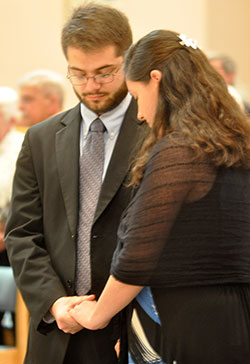 Daniel and Gabriela Ross hold hands for the blessing of married couples during the Marriage Day Mass at SS. Peter and Paul Cathedral on April 25. The couple was married on Dec. 27, 2015. (Photo by Natalie Hoefer)