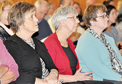 Cindy Clark, executive assistant for the archdiocesan Catholic Communications Center, left, Theresa Brydon, executive assistant to the archbishop, and Carolyn Noone, archdiocesan director of special events, watch a livestream of a Nov. 7 press conference in Newark, N.J., introducing Cardinal-designate Joseph W. Tobin as the new archbishop of Newark, N.J. (Photo by Sean Gallagher)