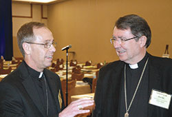 Archbishop–designate Charles C. Thompson of Indianapolis talks with Archbishop Christophe Pierre, apostolic nuncio to the United States, during a break at the spring meeting of the U.S. Conference of Catholic Bishops in Indianapolis on June 14. (Photo by John Shaughnessy)