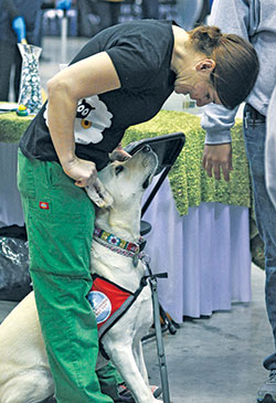 Judy McDonald interacts with her service dog Daisy during a past National Catholic Youth Conference in Indianapolis on Nov. 25, 2013. (File photo by Natalie Hoefer)