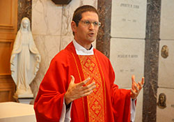 Father Eric Augenstein, archdiocesan vocations director, gives a homily during an Aug. 9, 2016, Mass at the chapel of Calvary Cemetery in Indianapolis during the annual archdiocesan seminarian convocation. As vocations director, Father Augenstein oversees the thorough evaluation process of potential seminarians for the archdiocese. (File photo by Sean Gallagher)