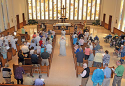 Archbishop Charles C. Thompson processes toward the altar in the chapel of the Little Sisters of the Poor’s St. Augustine Home for the Aged in Indianapolis on Aug. 30, 2017, to celebrate Mass. The home is one of four senior care facilities in the archdiocese based on Catholic values. (File photo by Natalie Hoefer)