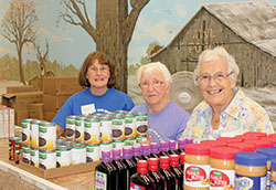 During an open house at Providence Food Pantry in West Terre Haute on Sept. 22, volunteers Randi Everett, left, Grace Puller and Annie Williams smile behind boxes of items offered by the ministry. The open house was held to mark Providence Food Pantry’s 25th anniversary. (Submitted photos by Shayna Tews)