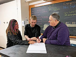 As part of the approach of the Men’s Warming Shelter of Bedford, Father Richard Eldred, pastor of St. Vincent de Paul Parish in Bedford and director Jennifer Richason help homeless men develop a plan to reach self-sufficiency. (Submitted photo)
