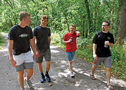 Archdiocesan seminarians Nathan Thompson, left, Randy Schneider, Samuel Rosko and Liam Hosty walk together on Aug. 10 at Fort Harrison State Park in Indianapolis. The outing to the state park was part of the annual convocation of archdiocesan seminarians in which the future priests have the chance to build up fellowship among themselves. (Photo by Sean Gallagher)