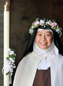 Discalced Carmelite Sister Marie Therese Miciano smiles while wearing a garland of flowers on Nov. 5, the day on which she professed solemn vows as a member of the Carmelite Monastery of St. Joseph in Terre Haute. (Submitted photo)