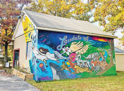 The renovated Community Pump House Art Studio sits on the grounds of the Conventual Franciscans in Mount St. Francis. Conventual Franciscan Father Vince Petersen and Louisville, Ky., artist Chris Chappell painted the Laudato Si’ mural on the studio. (Submitted photo)