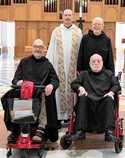 Benedictine Father Noël Mueller, left, Benedictine Father Joseph Cox, Benedictine Brother Jacob Grisley and Benedictine Father Ephrem Carr, four of the five Benedictine monks marking significant jubiliees this year at St. Meinrad Archabbey, pose in the Archabbey Church of Our Lady of Einsiedeln in St. Meinrad.  (Photo courtesy of Saint Meinrad Archabbey)