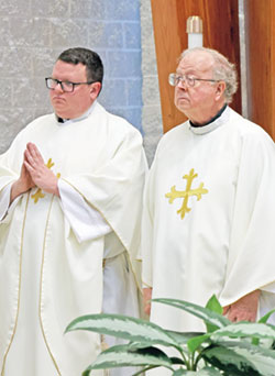 Father Joseph Rautenberg, right, concelebrates a Sept. 30 Mass at St. Mark the Evangelist Church in Indianapolis to celebrate the 75th anniversary of the founding of the faith community. A son of the parish, Father Rautenberg was ordained a priest in 1973. Concelebrating with him is Father James Brockmeier. (Submitted photo)