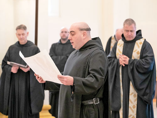 Benedictine Brother Gregory Morris reads on Jan. 25 from the hand-written document of his solemn vows as a monk of 
Saint Meinrad Archabbey in St. Meinrad.  The solemn profession of vows took place during a Mass in the Archabbey Church of Our Lady of Einsiedeln in St. Meinrad. Brother Gregory also shows the traditional haircut, known in Latin as “corona” (“crown”) given to monks at the monastery when they profess solemn vows. (Photo courtesy of Saint Meinrad Archabbey)