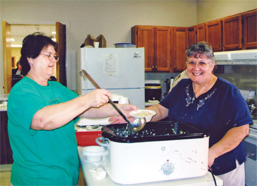 Serving up homemade chicken and noodles at the 2005 Rosary Society Craft Bazaar are, left to right, Joan Duncan and Dee Vincent. Vincent has been in charge of making the noodles for more than 25 years. (Submitted photo)