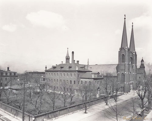 An archive photo dating from 1928 shows the campus of Sacred Heart of Jesus Parish in Indianapolis. The 165-foot tall twin steeples continue today to dominate the skyline of the near southside of the city. (Submitted archive photo from The Indiana Album)