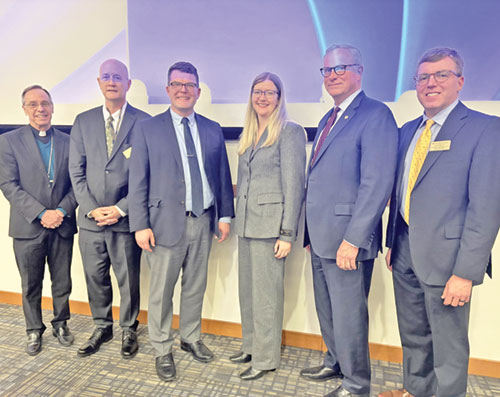 Archbishop Charles C. Thompson, left, Phil Thompson, Seth Smith, Megan Gooley, Marian University president Dan Elsener and John Noble, chair of Marian&rsquo;s theology department, pose on Feb. 11 at Marian University in Indianapolis. Archbishop Thomspon, Phil Thompson, Smith and Gooley took part that evening in a panel discussion about Pope Leo XIV. (Submitted photo)